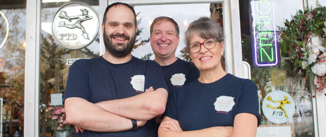 Happy Florists standing triumphantly outside their shop